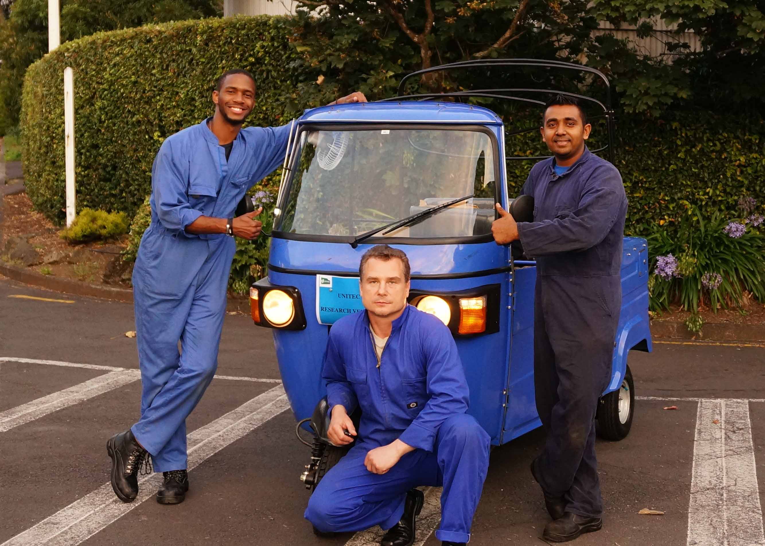 Unitec staff and students with the electric tuk-tuk