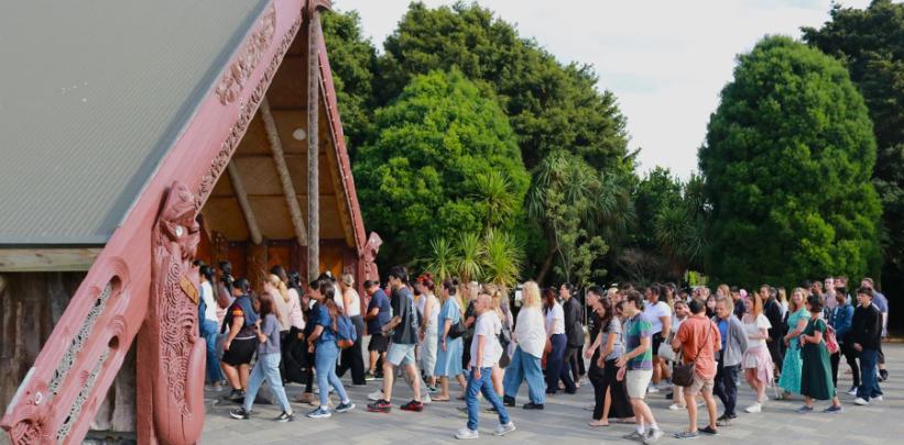 Healthcare and Social Practice students walking into the Marae